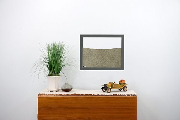 dark grey painted wood frame ant farm hanging on wall