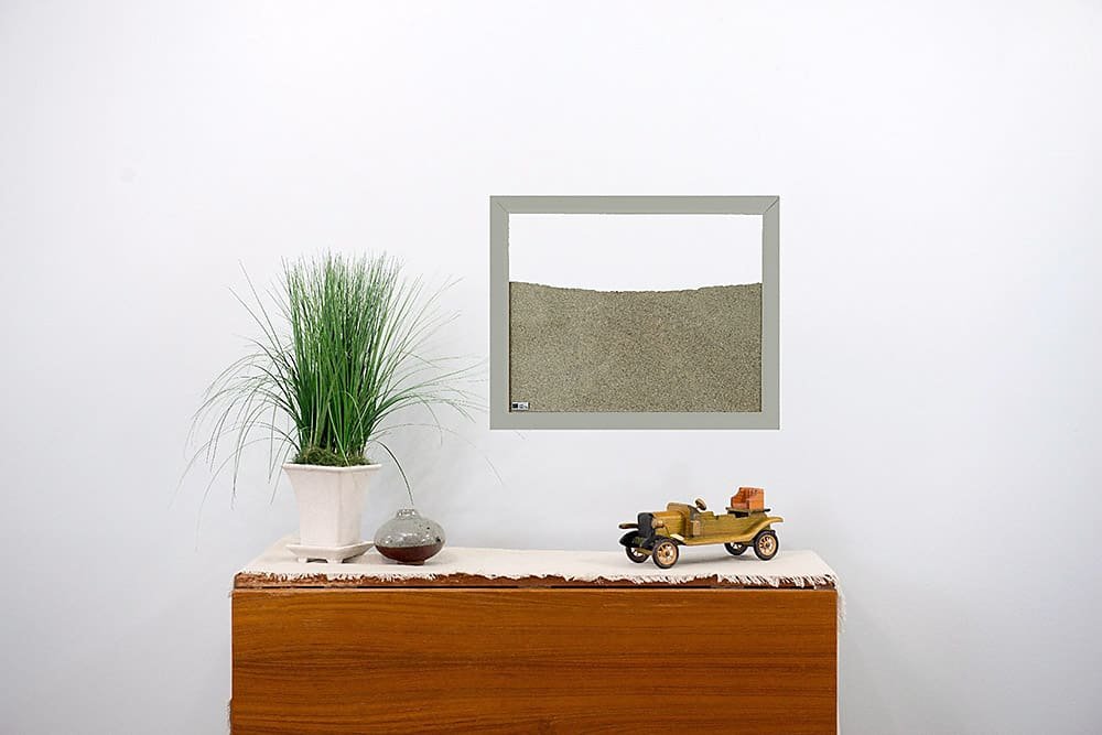 light grey painted wood frame ant farm hanging on wall