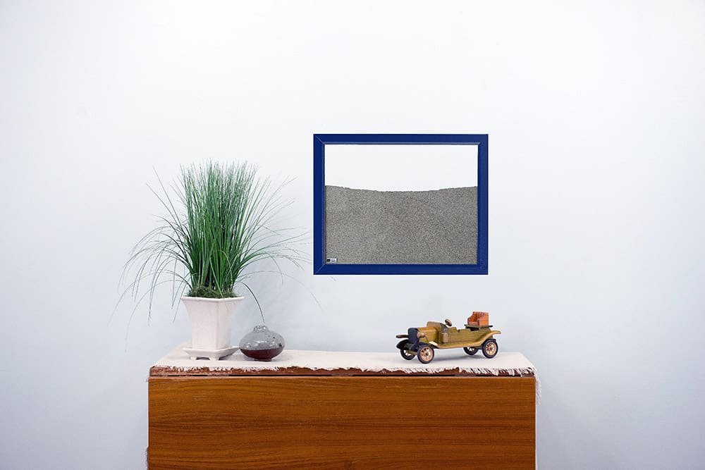 navy painted wood frame ant farm hanging on wall