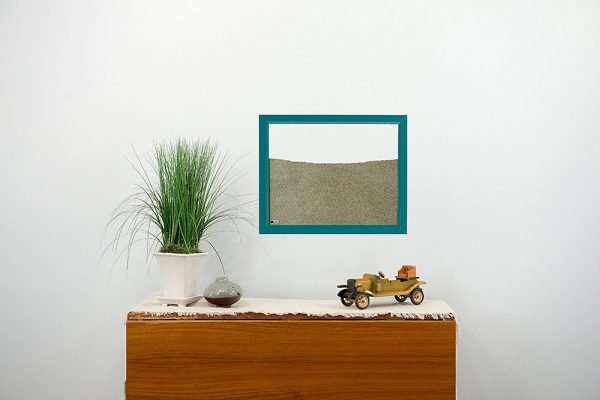 teal wood frame ant farm hanging on wall