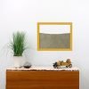 yellow wood frame ant farm hanging on wall